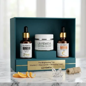The Brightening Trio skin care bundle by LaFemeia featuring Niacinamide Serum, Vitamin C Serum, and Extra Glow Whitening Cream displayed in a premium teal gift box in Pakistan.